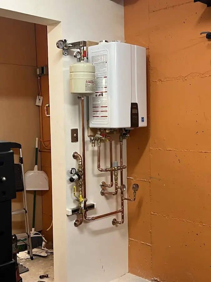 Plumbing technician inspecting water heater connections in Soquel